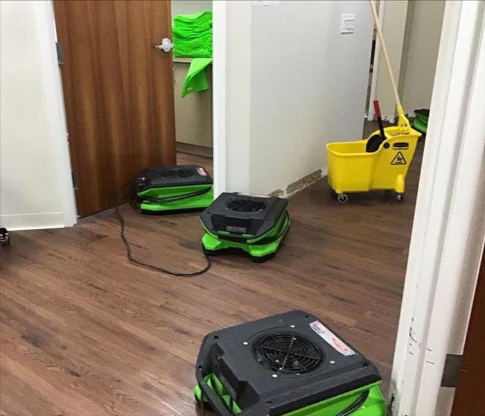 Open hallway with drying equipment on floor.