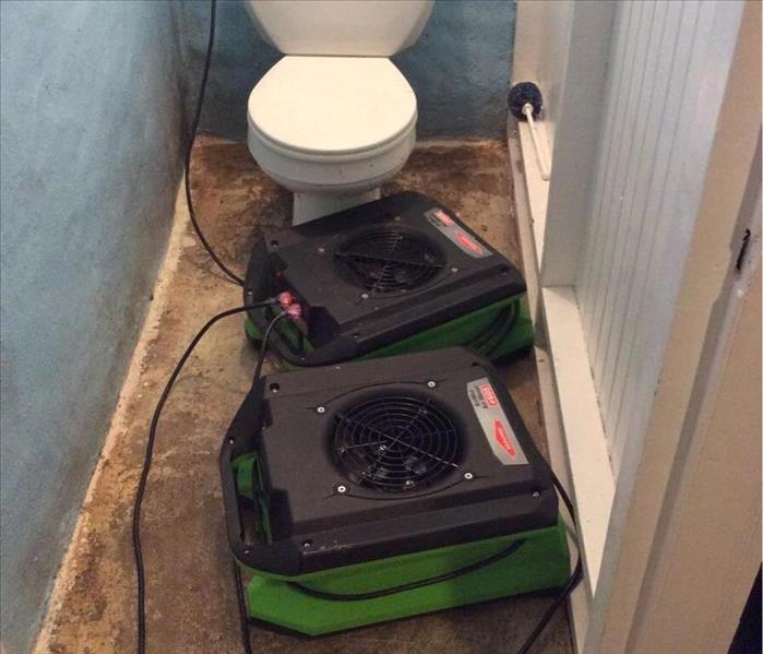 Two air dryers set up in a bathroom.
