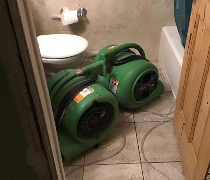 Two air dryers in a bathroom.