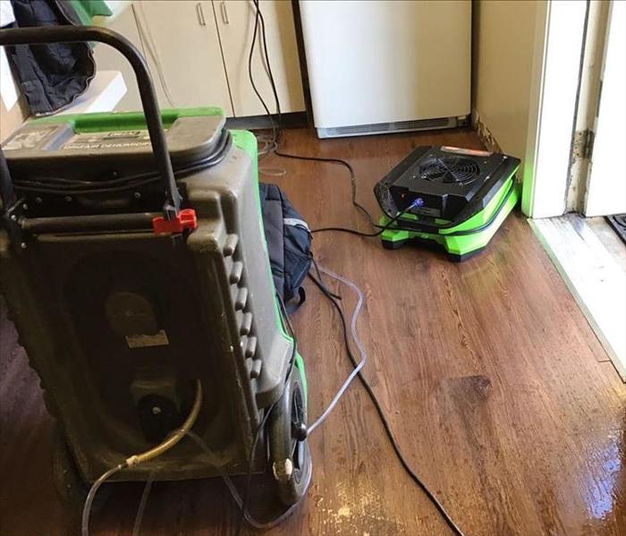 Green drying equipment set up in a break room.