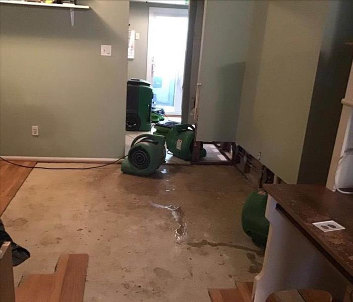 Drying equipment set up on bedroom floor.