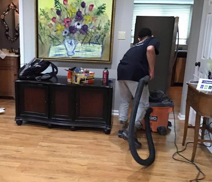 SERVPRO employee extracting water in office