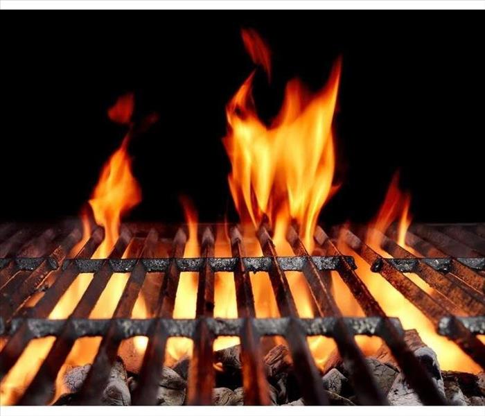 Hot Empty Charcoal BBQ Grill With Bright Flames On The Black Background. Cookout Concept.